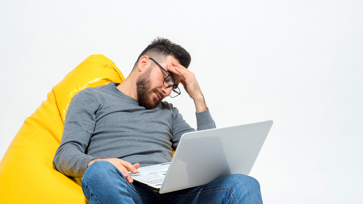 A frustrated guy in front of a laptop